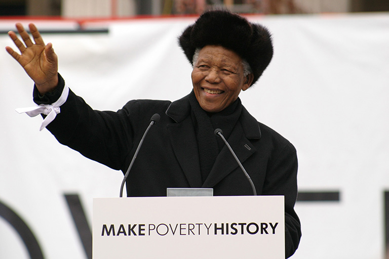 Nelson Mandela addresses over 22,000 people in Trafalgar Square on behalf of the MAKEPOVERTYHISTORY coalition. He hands a group of school children his white band to be delivered with thousands of others to the leaders of the G8.